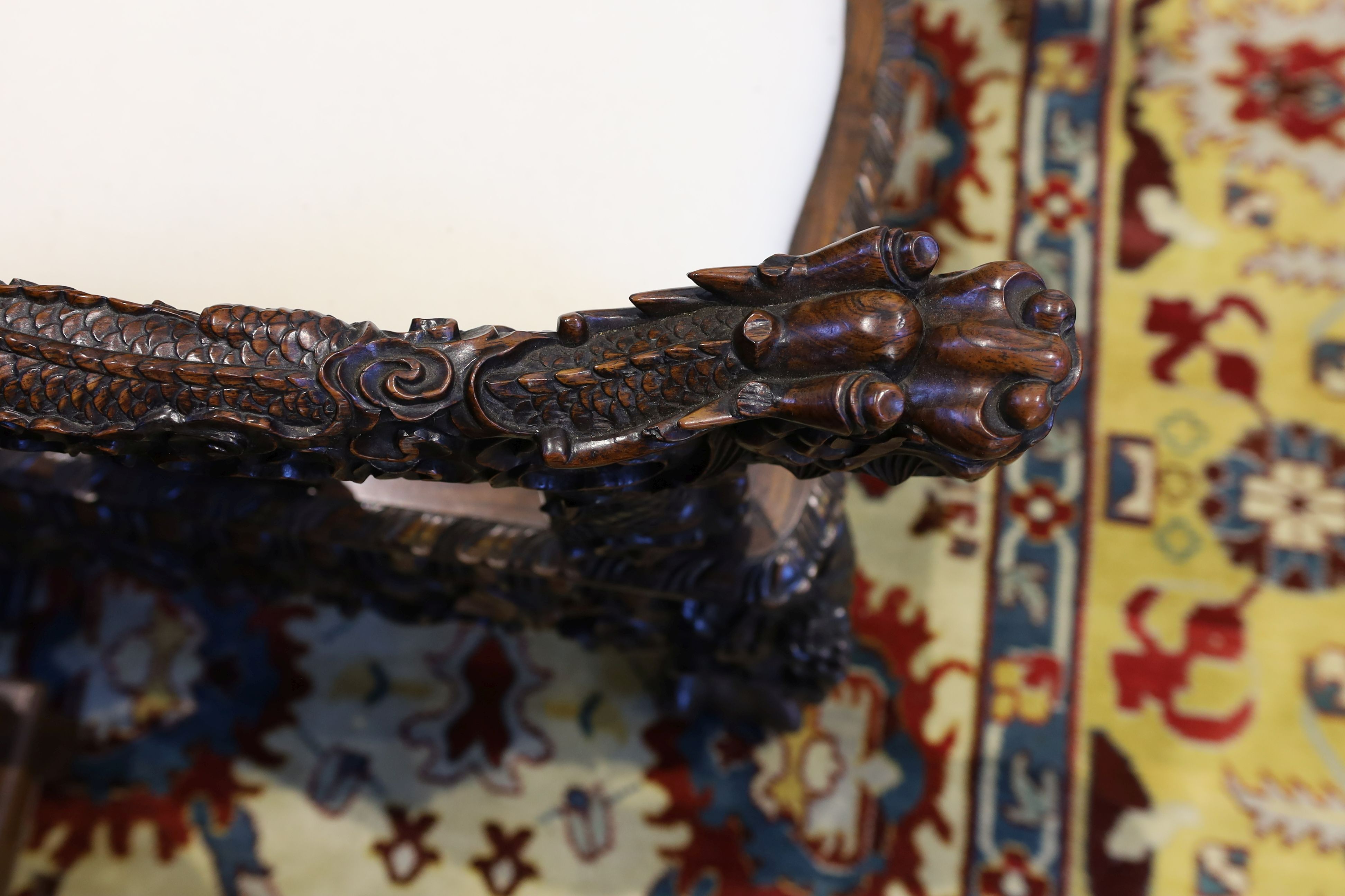 A good Chinese hardwood ‘dragon’ throne armchair, c.1900, 114.5cm high, 68cm wide at the arms